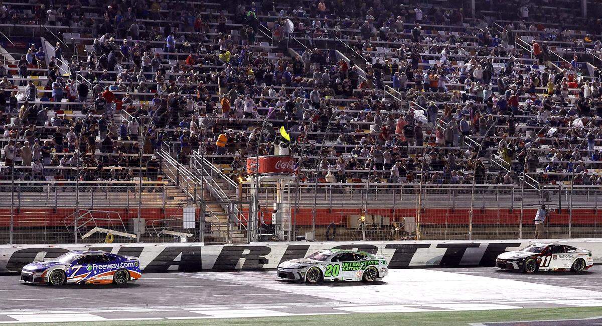 NASCAR driver Daniel Suarez leads drivers Christopher Bell and Denny Hamlin across the finish line as the yellow caution flag is waved during the Coca-Cola 600 at Charlotte Motor Speedway in Concord, NC on Sunday, May 24, 2026. Suarez would be declared the winner.