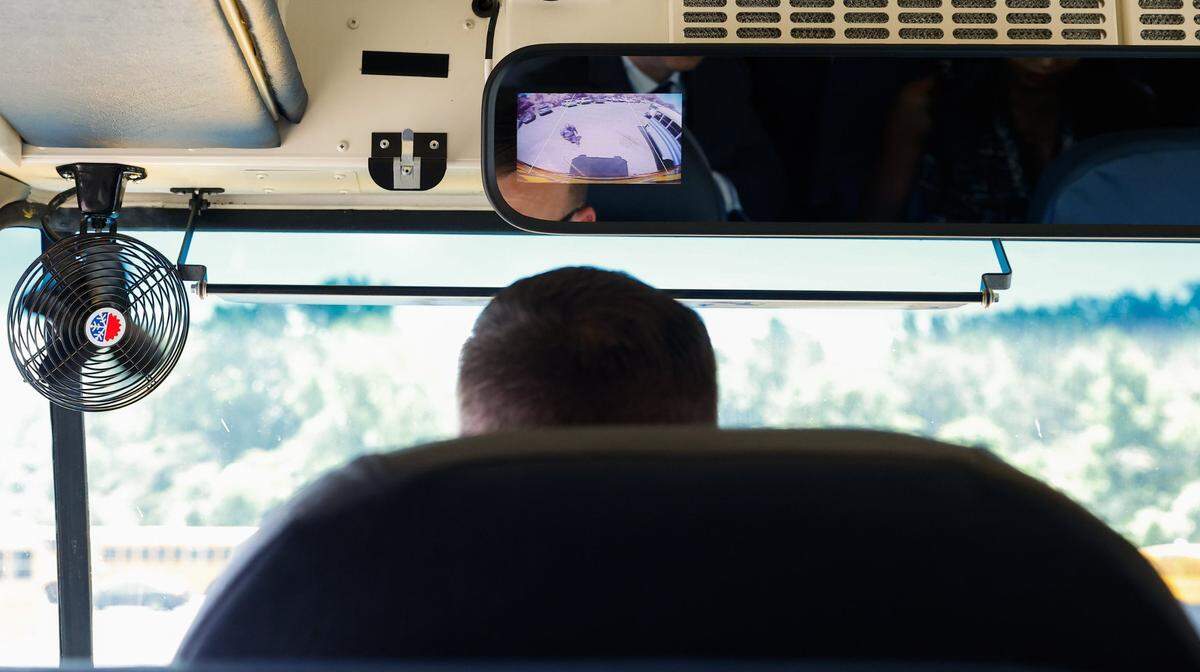 An image from a backup camera appears on the rearview mirror above the driver of an electric school bus on Thursday, June 6, 2024. The U.S. Environmental Protection Agency’s 2023 Clean School Bus Program helps fund school districts in nearly every state to replace diesel fueled school buses that have been linked to asthma and other conditions that harm the health of students and surrounding communities.