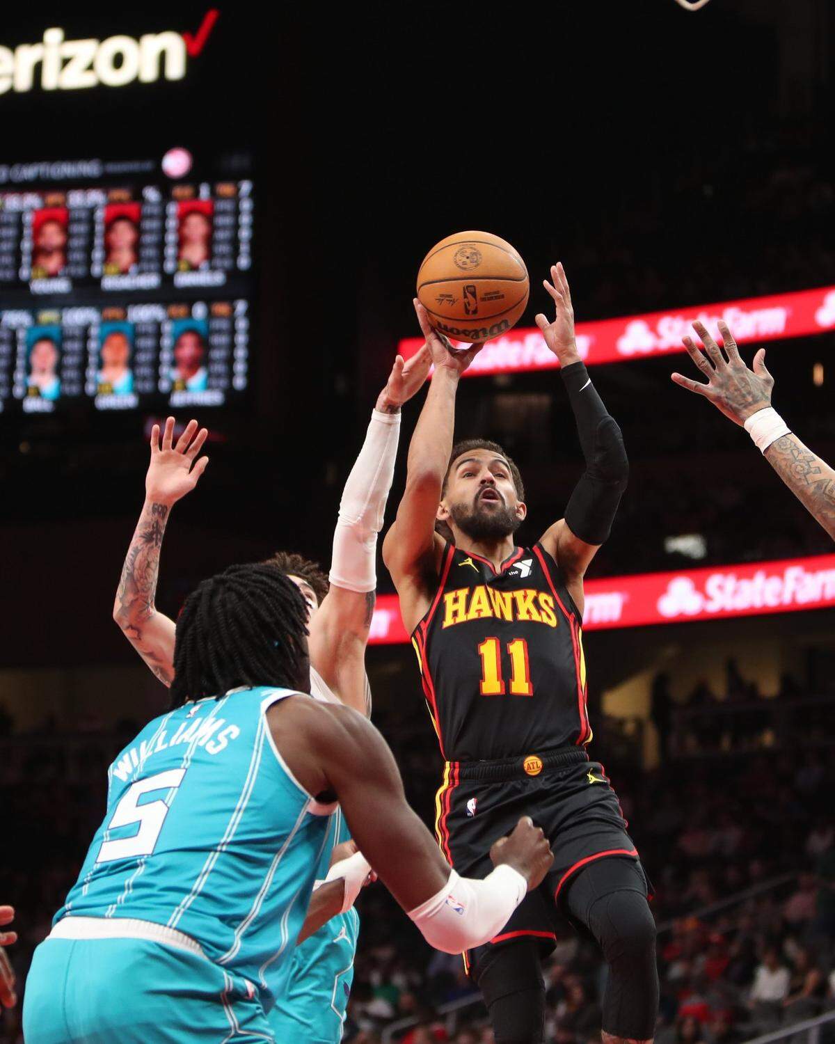 Atlanta Hawks guard Trae Young (11) shoots behind Charlotte Hornets center Mark Williams (5) during the first quarter at State Farm Arena.