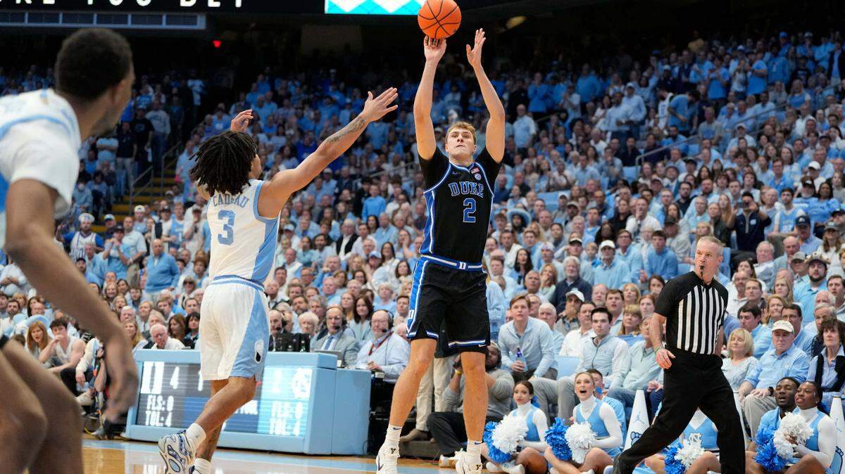 Mar 8, 2025; Chapel Hill, North Carolina, USA; Duke Blue Devils forward Cooper Flagg (2) shoots as North Carolina Tar Heels guard Elliot Cadeau (3) defends in the first half at Dean E. Smith Center.