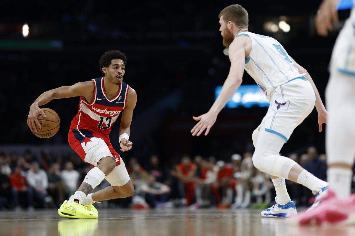 Washington Wizards guard Jordan Poole (13) dribbles the ball as Charlotte Hornets forward Davis Bertans (9) defends in the first half at Capital One Arena.