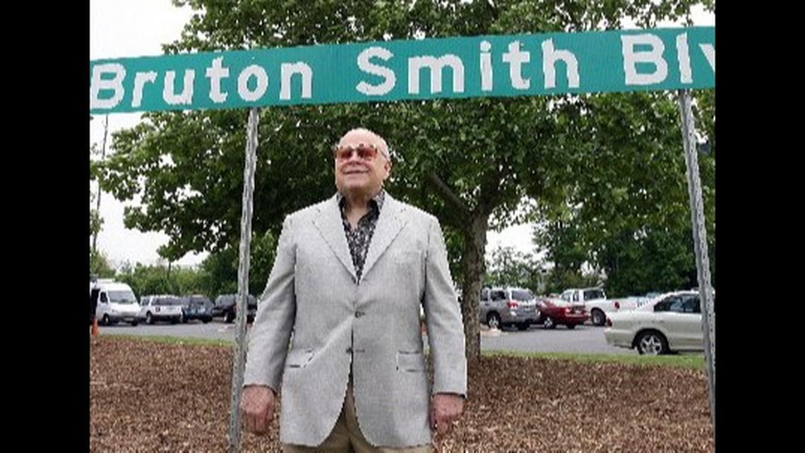 NASCAR track owner Bruton Smith died Wednesday at age 95. Here he poses in front of one of the Bruton Smith Boulevard road signs, which leads to Charlotte Motor Speedway in Concord.