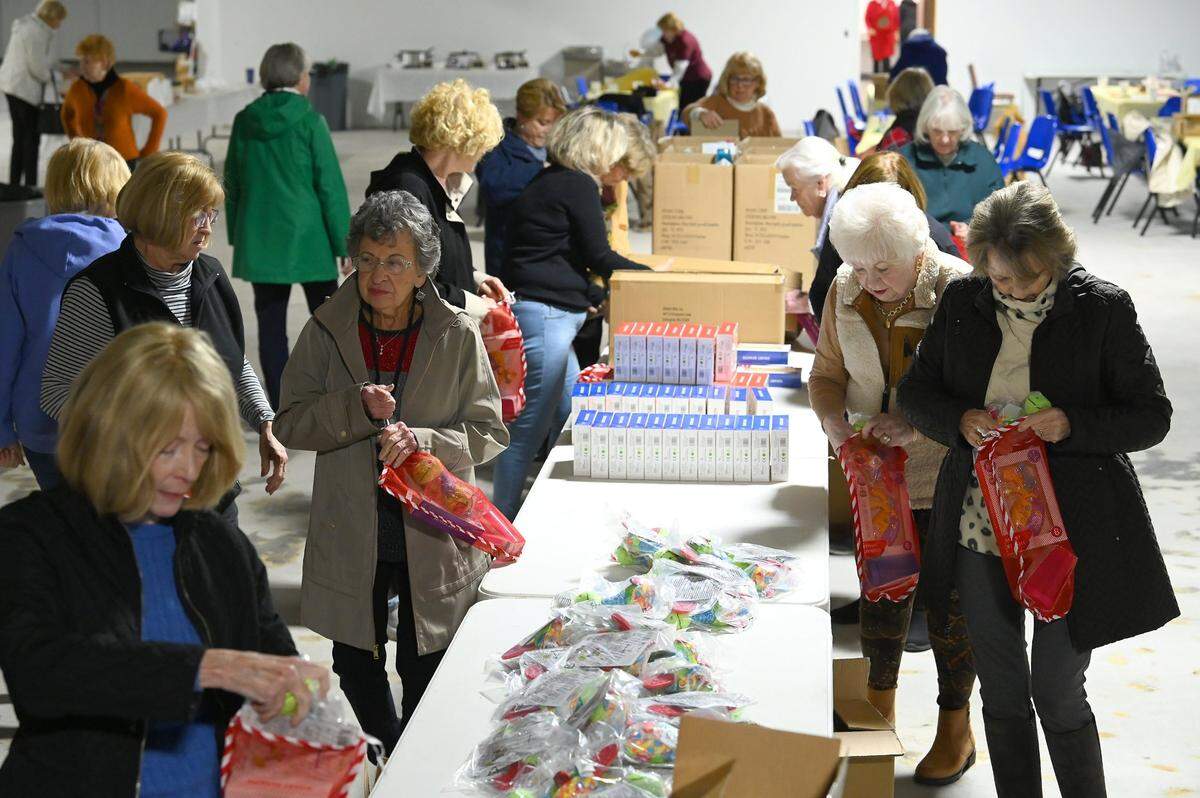 Volunteers with the Salvation Army Women’s Auxiliary of Greater Charlotte gather Christmas stocking items for kids in this 2022 file photo. Charlotte Observer readers donated $118,405 to the paper’s Empty Stocking Fund during the 2024 holiday season.