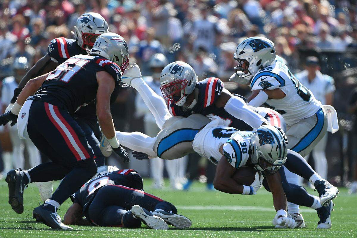 New England Patriots linebacker K'Lavon Chaisson (44) tackles Carolina Panthers running back Chuba Hubbard (30) during Sunday’s first half at Gillette Stadium.