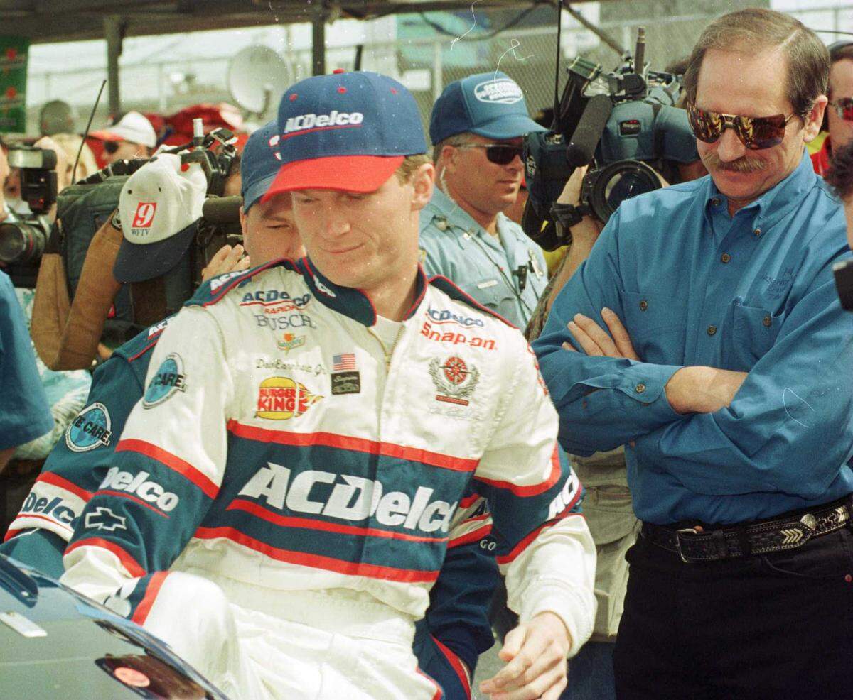 2/15/98 JEFF SINER/The Charlotte Observer Dale Earnhardt Jr. (left) went out to make his father (right) proud in the February 1998 NAPA 300. Earnhardt’s racing was impressive, but an error in the pits and a spectacular crash left him in 37th place.