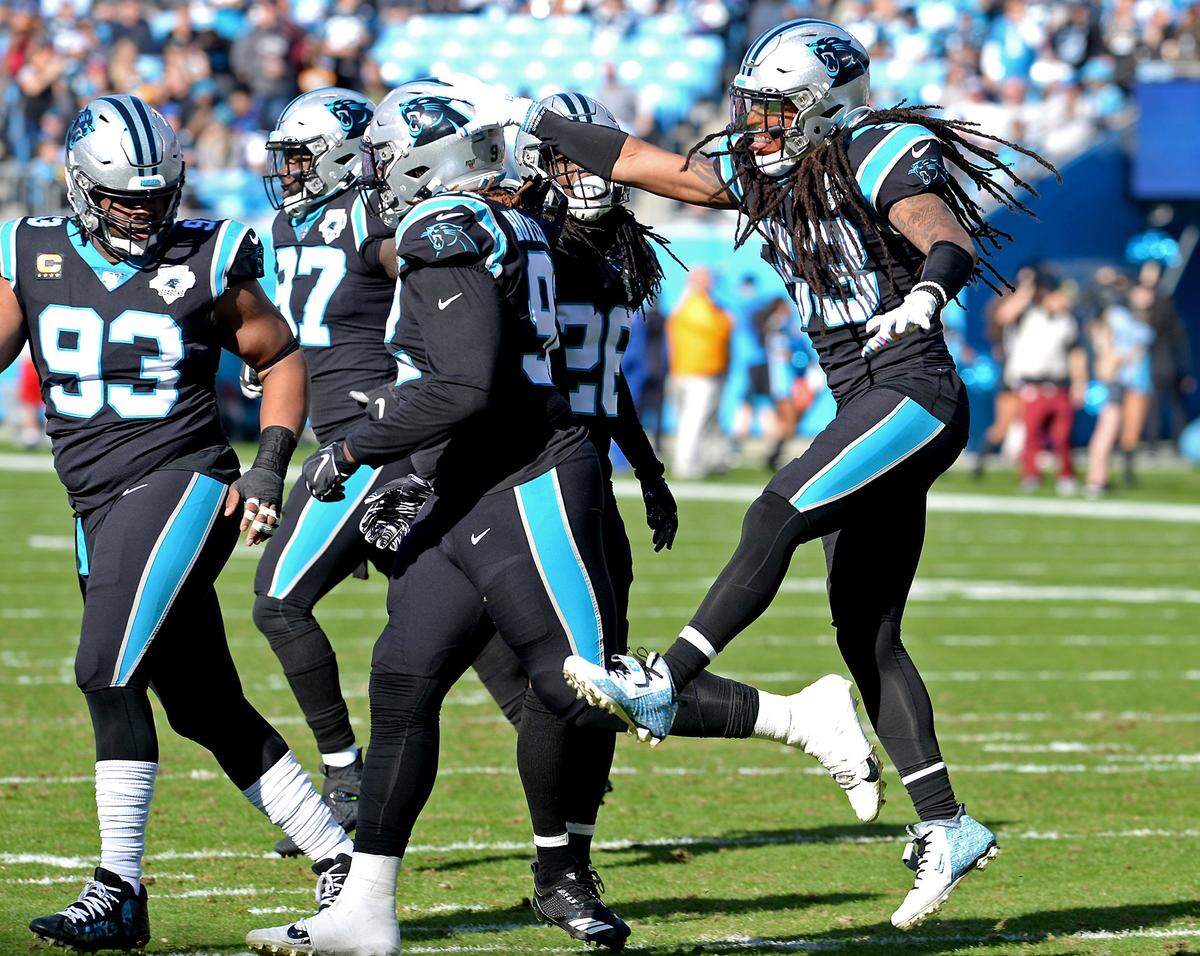 Carolina Panthers safety Tre Boston, right, reaches out to congratulate defensive tackle Vernon Butler (center) in December while Gerald McCoy (93) looks on. All three players are set to become free agents.