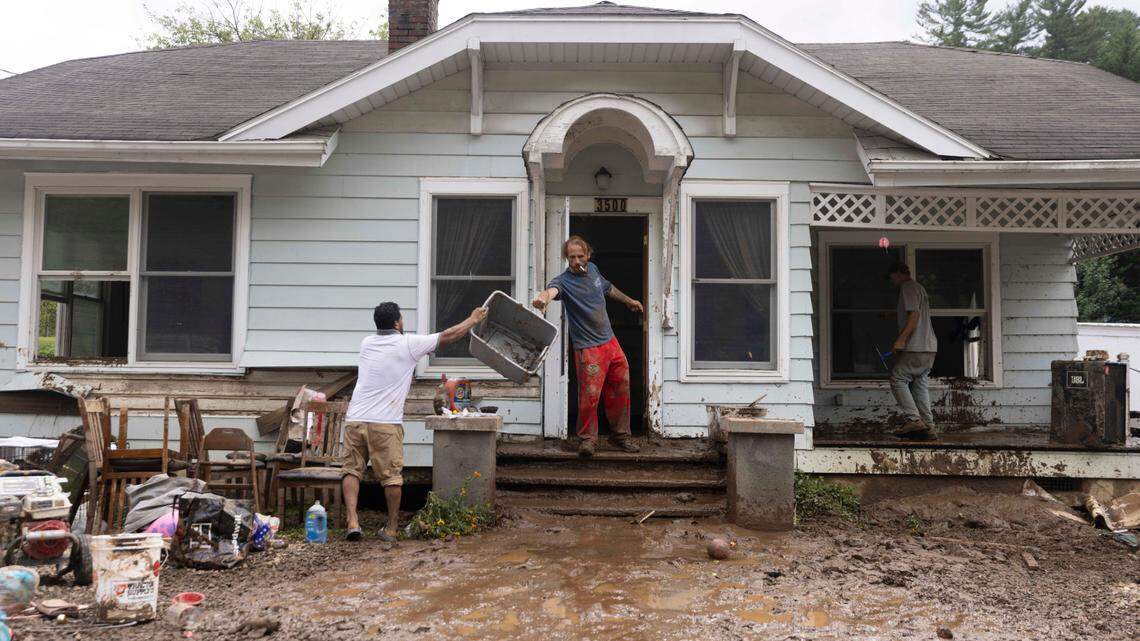 Residents in Clyde begin cleaning up on Saturday, Sept. 28, 2024 after massive flooding damaged dozens of homes and businesses. The remnants of Hurricane Helene caused widespread flooding, downed trees, and power outages in western North Carolina.