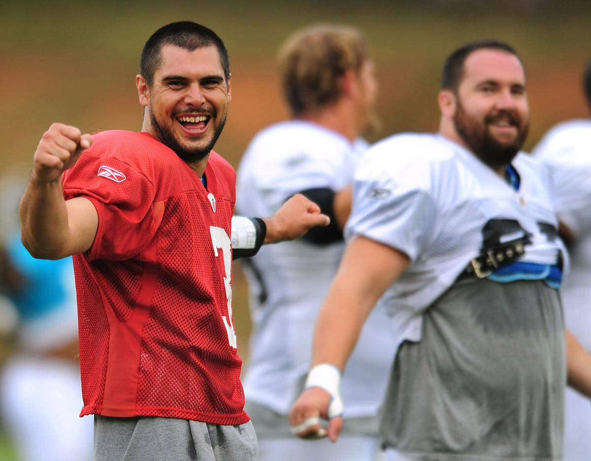 Matt Moore (far left) shares a laugh with center Ryan Kalil at training camp in 2010.