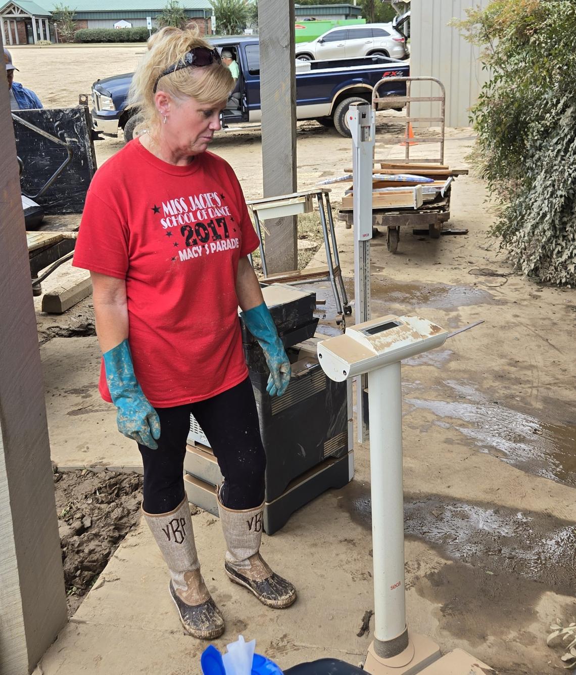Vicki Brown, an office manager for Faith Primary Care Plus, observes damage to a weight scale.