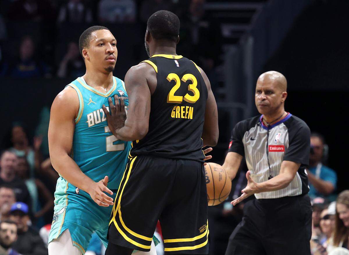 Charlotte Hornets forward Grant Williams, left, stands in place as Golden State Warriors forward Draymond Green, right, puts a hand into Williams’ chest during second-half action at Spectrum Center in Charlotte, NC on Friday, March 29, 2024. The Warriors defeated the Hornets 115-97.