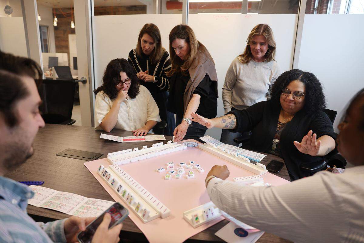 The Queen's Mahjery founders, Lauren Ulrey, second from left, Jennifer Ross and Patti Roth, instruct Charlotte Observer newsroom stafff how to play Mahjong on Wednesday, Feb. 11, 2026 in Charlotte.