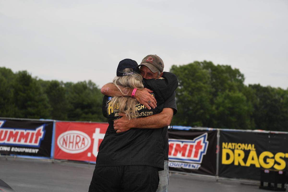 Paul Freer hugs his daughter Lauren in Norwalk, Ohio, in June 2023, when she recorded her history-making double and became the first woman to win twice in one day at an NHRA-sanctioned event.