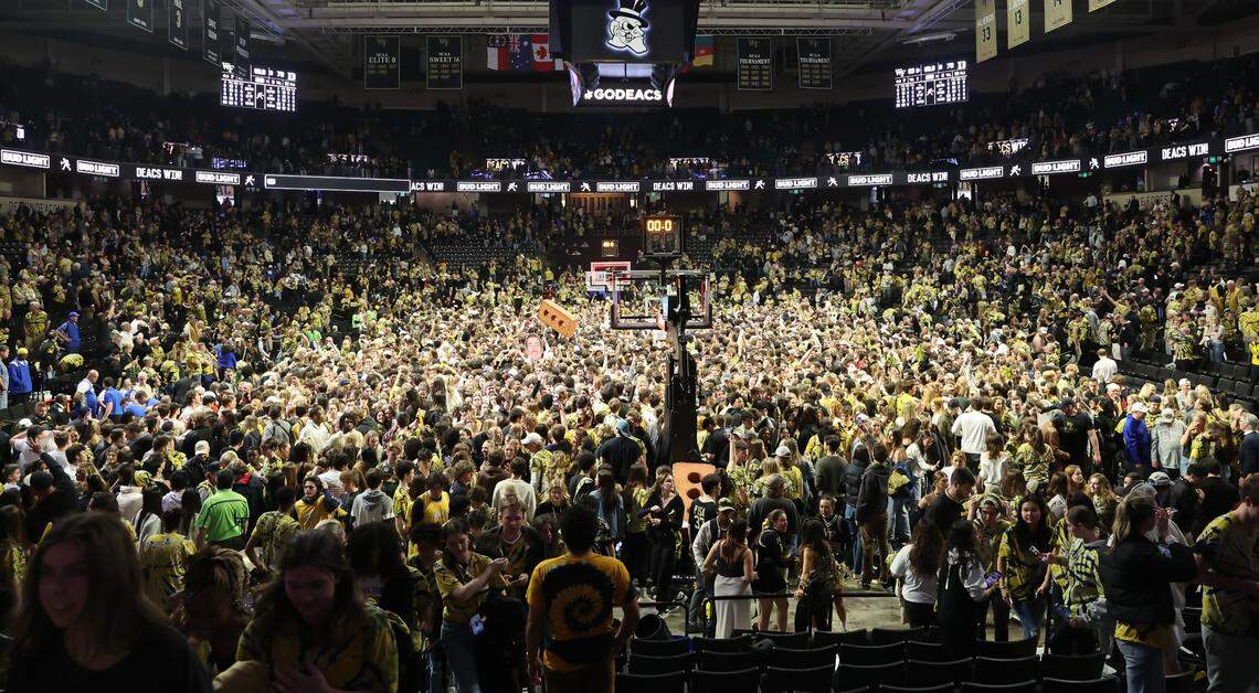 Wake Forest Demon Deacons students storm the court after Wake Forest beat the Duke Blue Devils at Lawrence Joel Veterans Memorial Coliseum in February 2024.