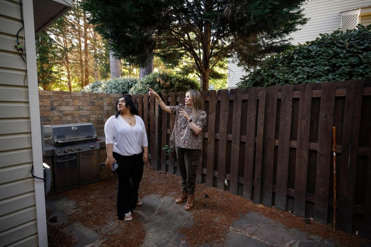 Rochelle Vassar, left, tours a townhome with her agent, Julie Taché, earlier this month.