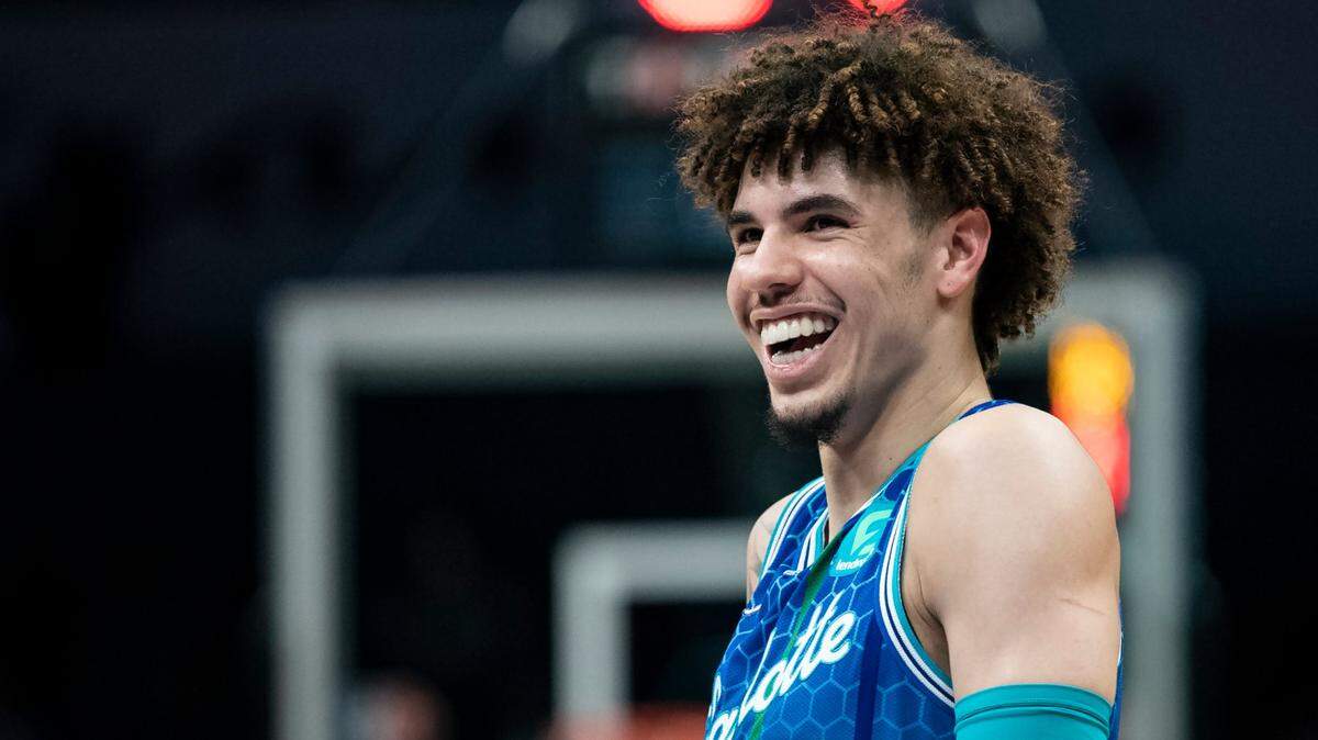 Charlotte Hornets guard LaMelo Ball (2) smiles during the first half of an NBA basketball game against the Milwaukee Bucks, Saturday, Jan. 8, 2022, in Charlotte, N.C. (AP Photo/Matt Kelley)