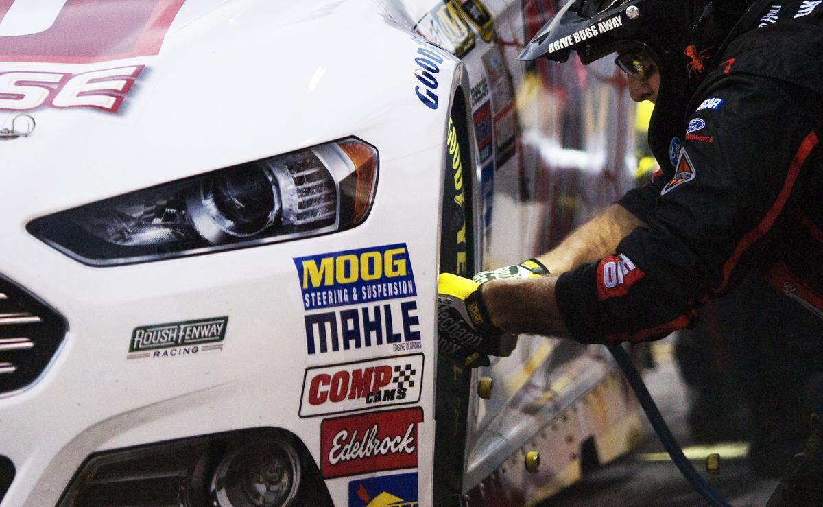 Sprint Cup Series driver Greg Biffle (16) and his pit crew change out tires during the qualifying lap at the All-Star Race at Charlotte Motor Speedway in Concord, NC on Saturday May 15, 2015. 
