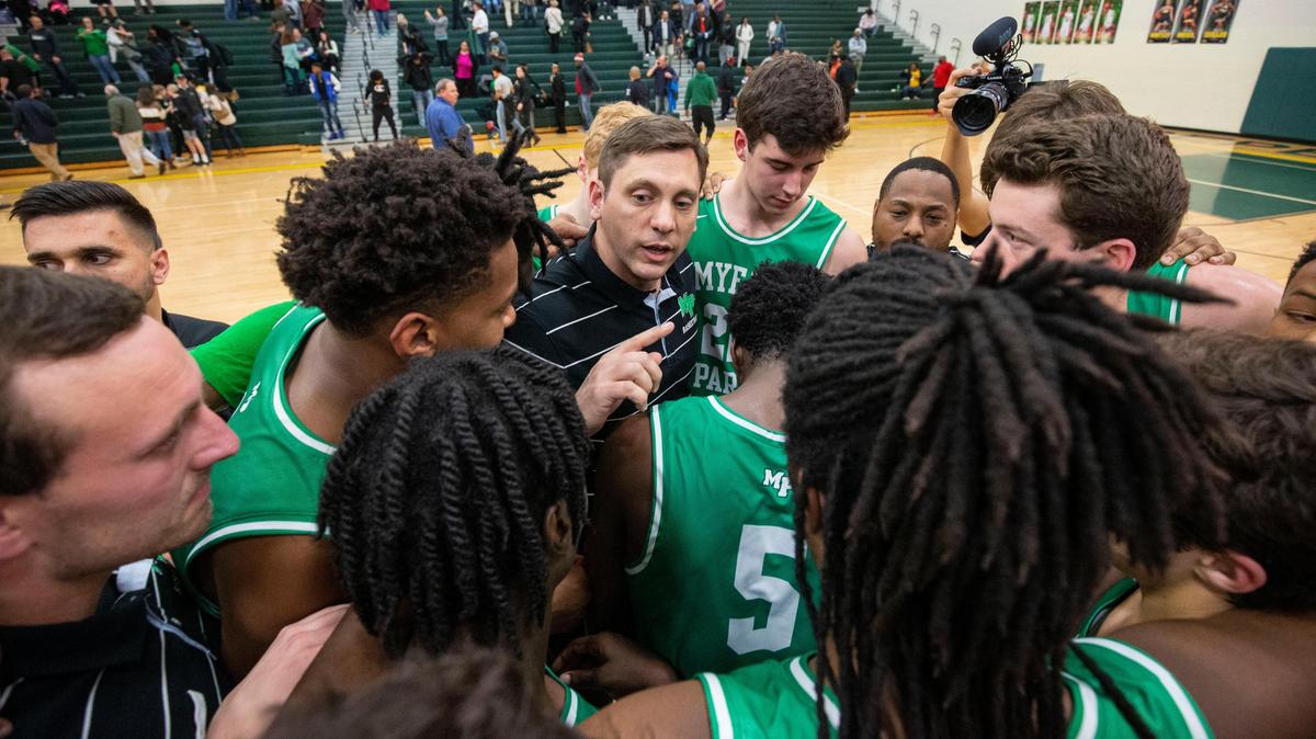 Myers Park head coach Scott Taylor gathers his team after winning against Myers Park 77-72 after a game at Independence High School in Charlotte, NC on Friday, January 17, 2020.