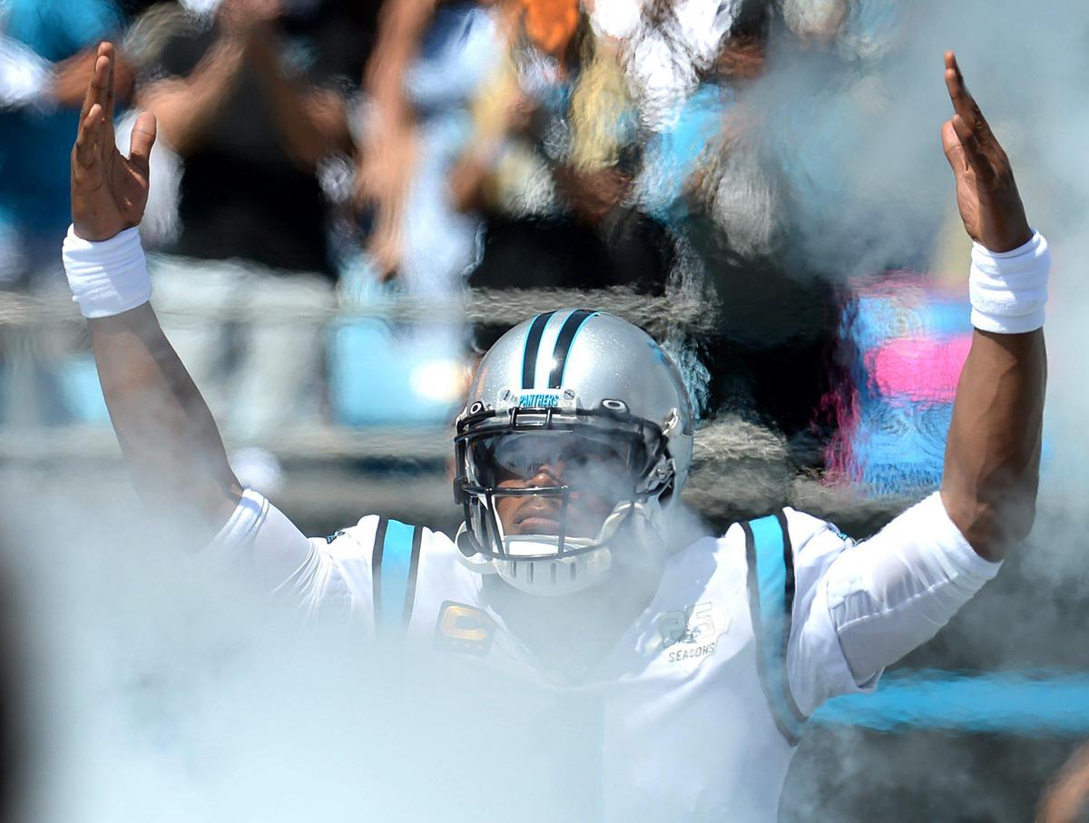 Carolina Panthers quarterback Cam Newton looks to get the fans involved as he is introduced Sunday before Carolina’s 30-27 loss to the Los Angeles Rams.