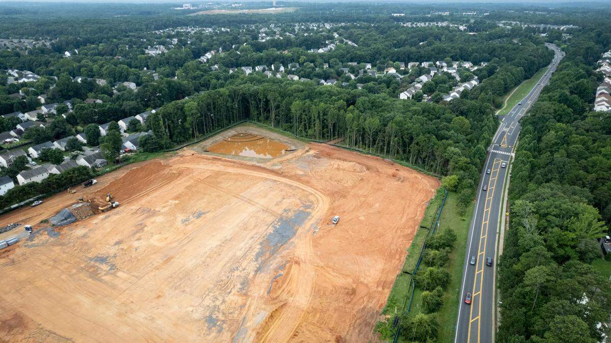 Charlotte-Mecklenburg Schools is working on plans for a “teacher village” that will provide affordable housing for its educators. The plans haven’t moved into construction yet, and CMS says it won’t have to pay for the housing. This file photo from 2022 shows a school being built on land surrounded by houses in south Charlotte.