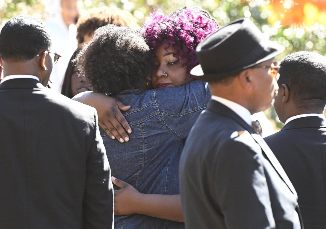 Ashley Mewborn, mother of Butler High shooting victim Bobby McKeithen, is hugged outside the Progressive Baptist Church after stepping outside during funeral services for the Butler High School student on Saturday, November 3, 2018.