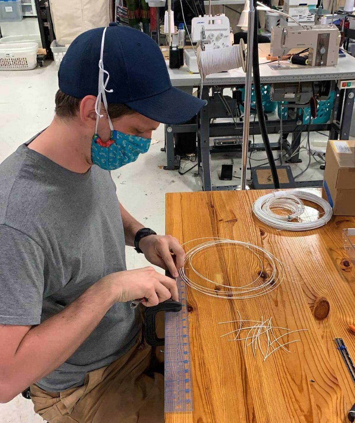 John Tringas measures and cuts wire for masks in the Charlotte Ballet costume shop.