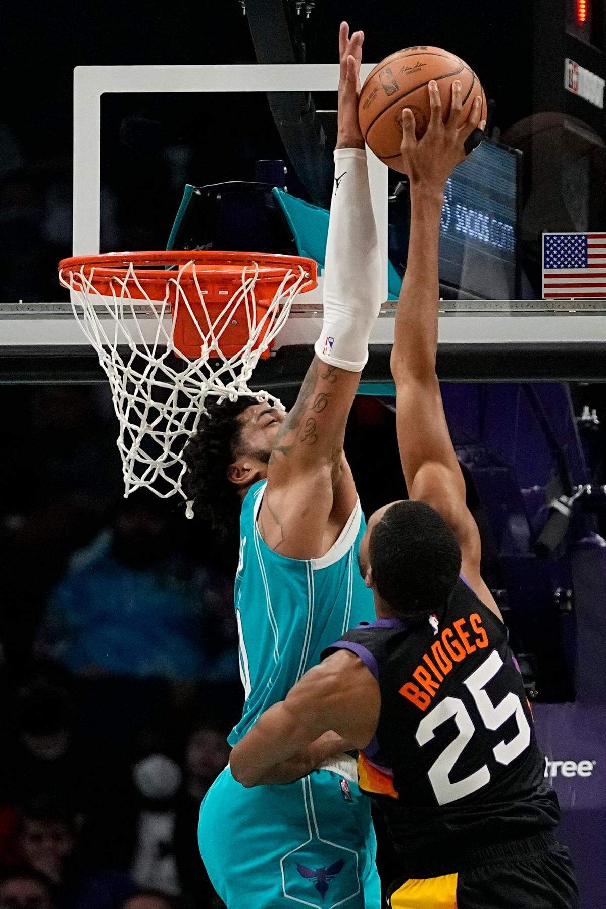 Charlotte Hornets forward Miles Bridges blocks a shot by Phoenix Suns forward Mikal Bridges during the second half of an NBA basketball game on Sunday, Jan. 2, 2022, in Charlotte, N.C. Phoenix won, 133-99.