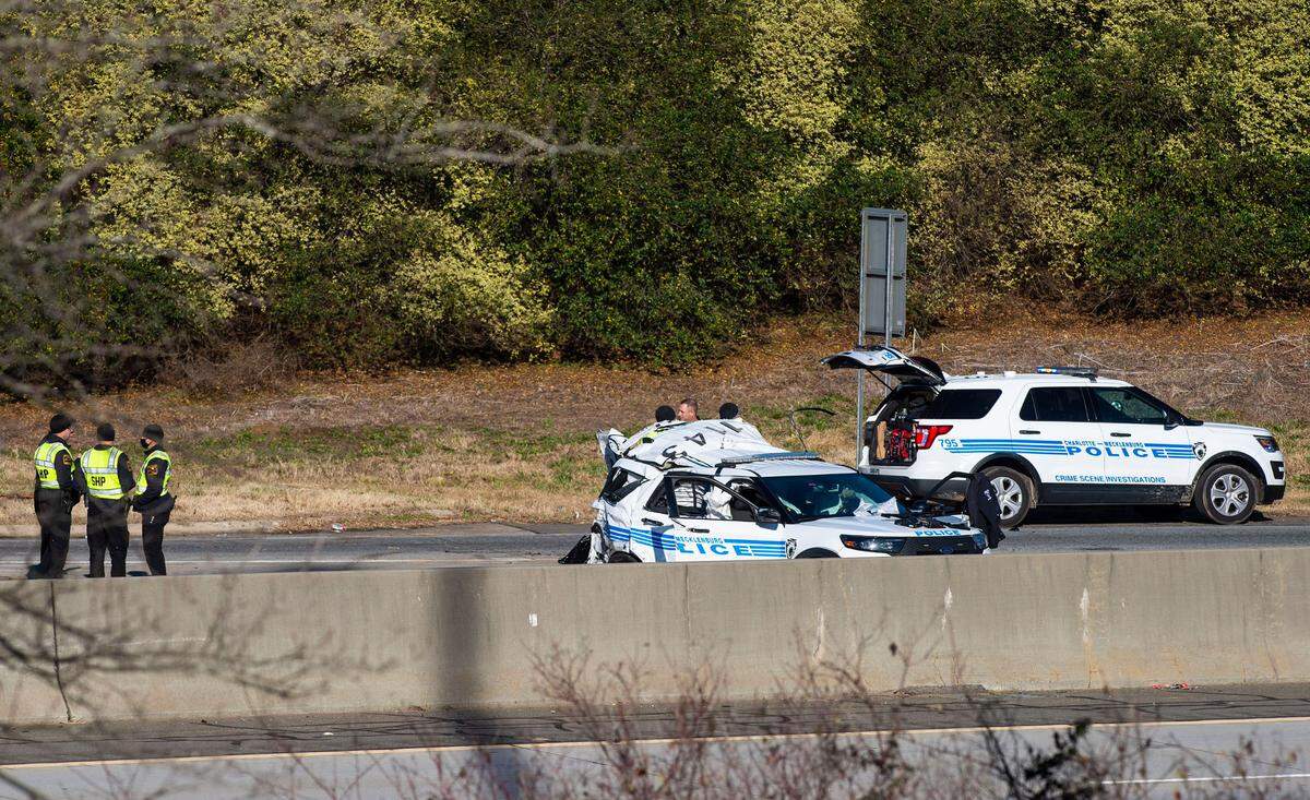 Charlotte-Mecklenburg police and North Carolina State Highway Patrol troopers investigate the scene of a crash on Interstate 85 near the WT Harris Boulevard exit that killed Officer Mia Goodwin and injured three others on Wednesday, December 22, 2021 in Charlotte, NC.