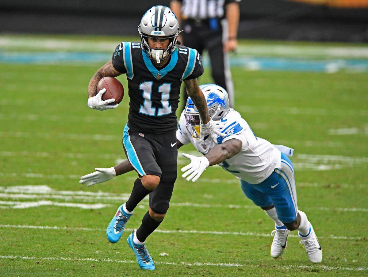 Carolina Panthers wide receiver Robby Anderson (11) runs past Detroit Lions safety Jayron Kearse (42) after a reception in the second half at Bank of America Stadium in Charlotte, NC on Sunday, November 22, 2020. The Panthers won, 20-0.
