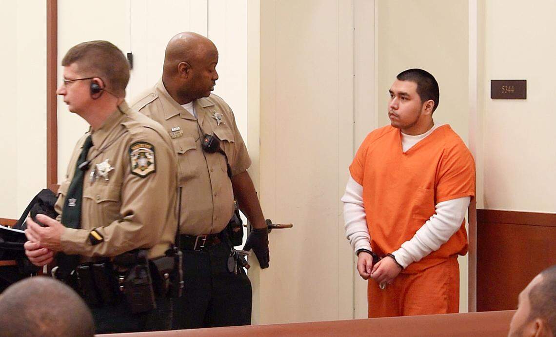 At a court hearing in November 2018, a judge denied bond for Carlos Olguin, pictured here in an orange jail jumpsuit.