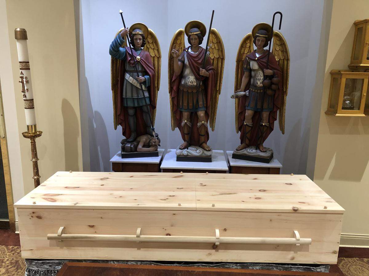 A wooden coffin of longtime Charlotte Motor Speedway president and general manager H.A. “Humpy” Wheeler lies inside Saint Gabriel Catholic Church in Charlotte on Tuesday, August 26, 2025