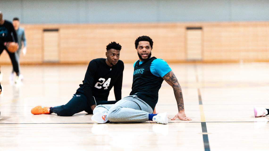 Charlotte Hornets' Brandon Miller (left) and Miles Bridges share a moment during practice at UCLA on Thursday.