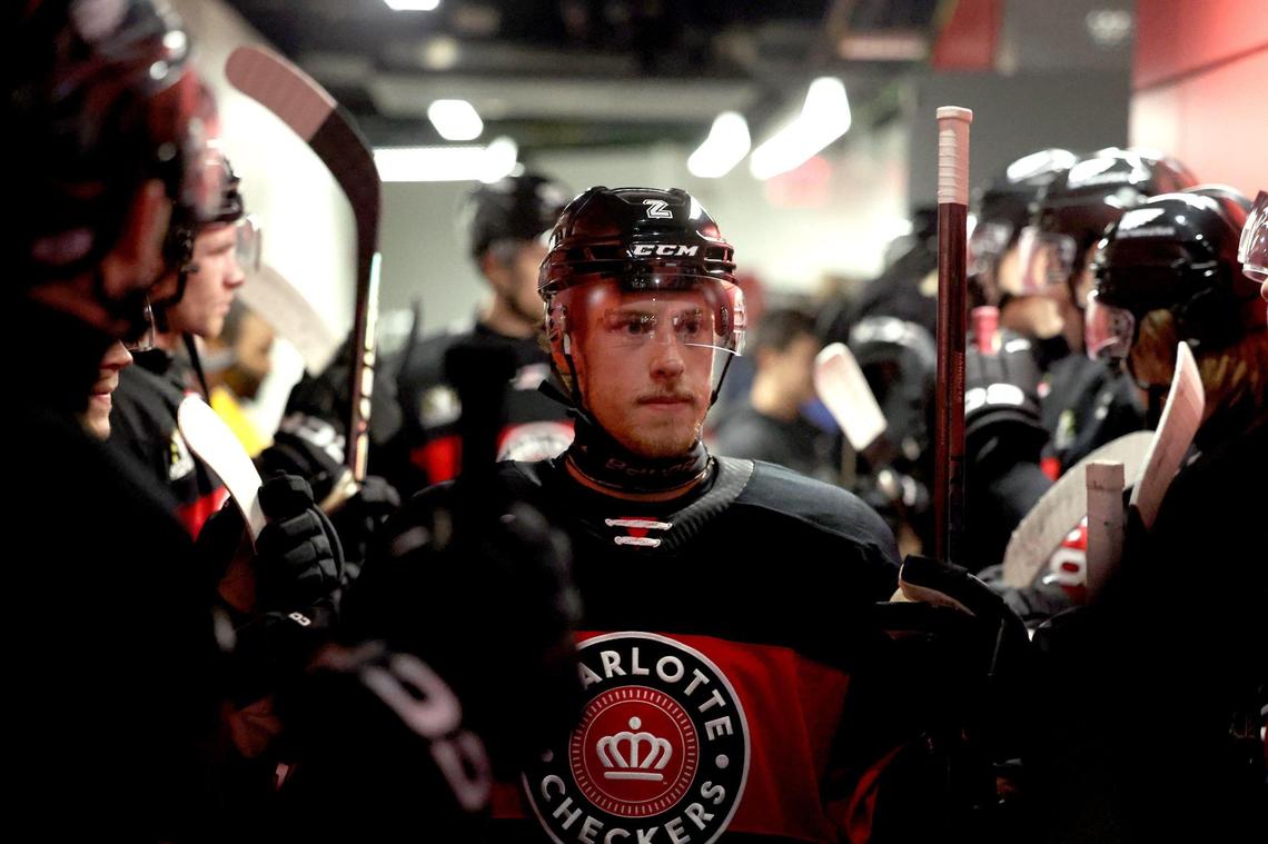 The Charlotte Checkers line a hallway prior to being introduced to the opening night crowd at Bojangles Coliseum in Charlotte, NC on Friday, October 18, 2024. The Checkers hosted the Cleveland Monsters.