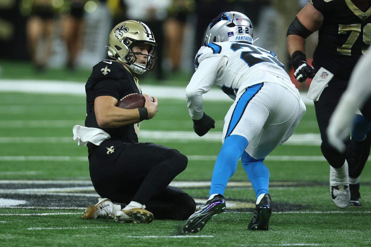 New Orleans Saints quarterback Tyler Shough (6) slides and is hit by the Carolina Panthers’ Lathan Ransom (22) during Sunday’s fourth quarter at Caesars Superdome. Ransom’s hit resulted in a 15-yard penalty and an easier potential game-winning field goal for the Saints, who won, 20-17.