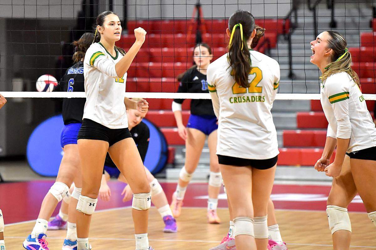 Cardinal Gibbons’ Charlotte Bell ( 12) and teammates react to wining a point against Marvin Ridge in the 2024 NCHSAA 4A Volleyball Championships. The Marvin Ridge Mavericks took on the Cardinal Gibbons Crusaders in the NCHSAA 4A Volleyball Championship match in Raleigh, N.C. on November 2, 2024.