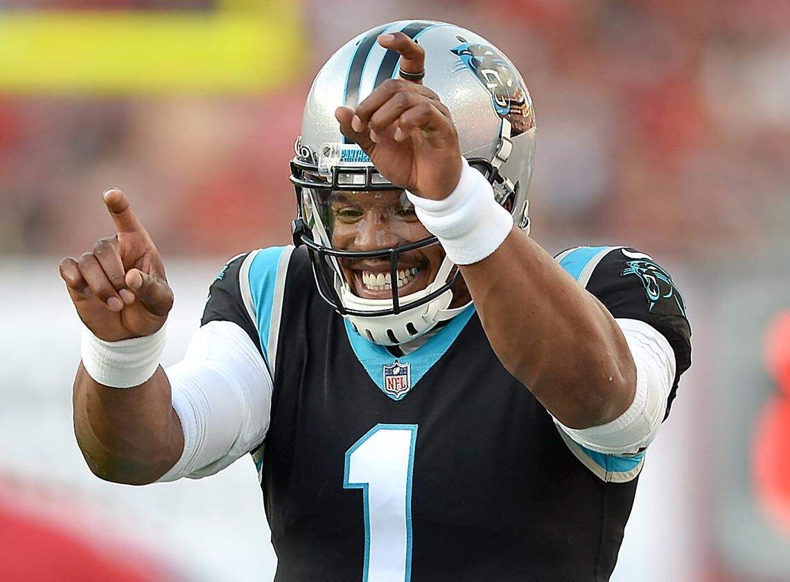 Carolina Panthers quarterback Cam Newton celebrates quarterback Sam Darnold’s touchdown pass to running back Chuba Hubbard during first-quarter action against the Tampa Bay Buccaneers at Raymond James Stadium in Tampa, Fl. on Sunday, January 9, 2022. Newton played only one play in Carolina’s 41-17 loss.