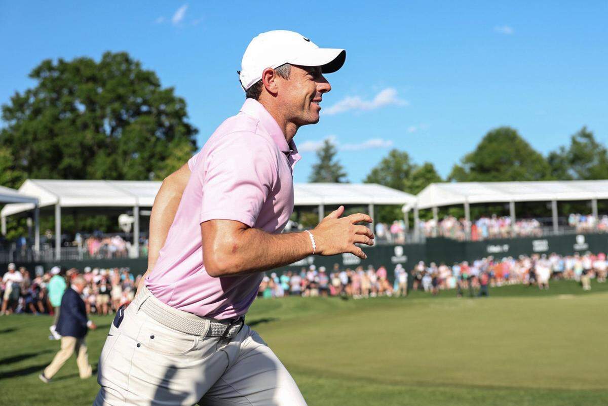 Rory McIlroy runs off the course after winning the Wells Fargo Championship at Quail Hollow Club in Charlotte, NC on Sunday, May 12, 2024.
