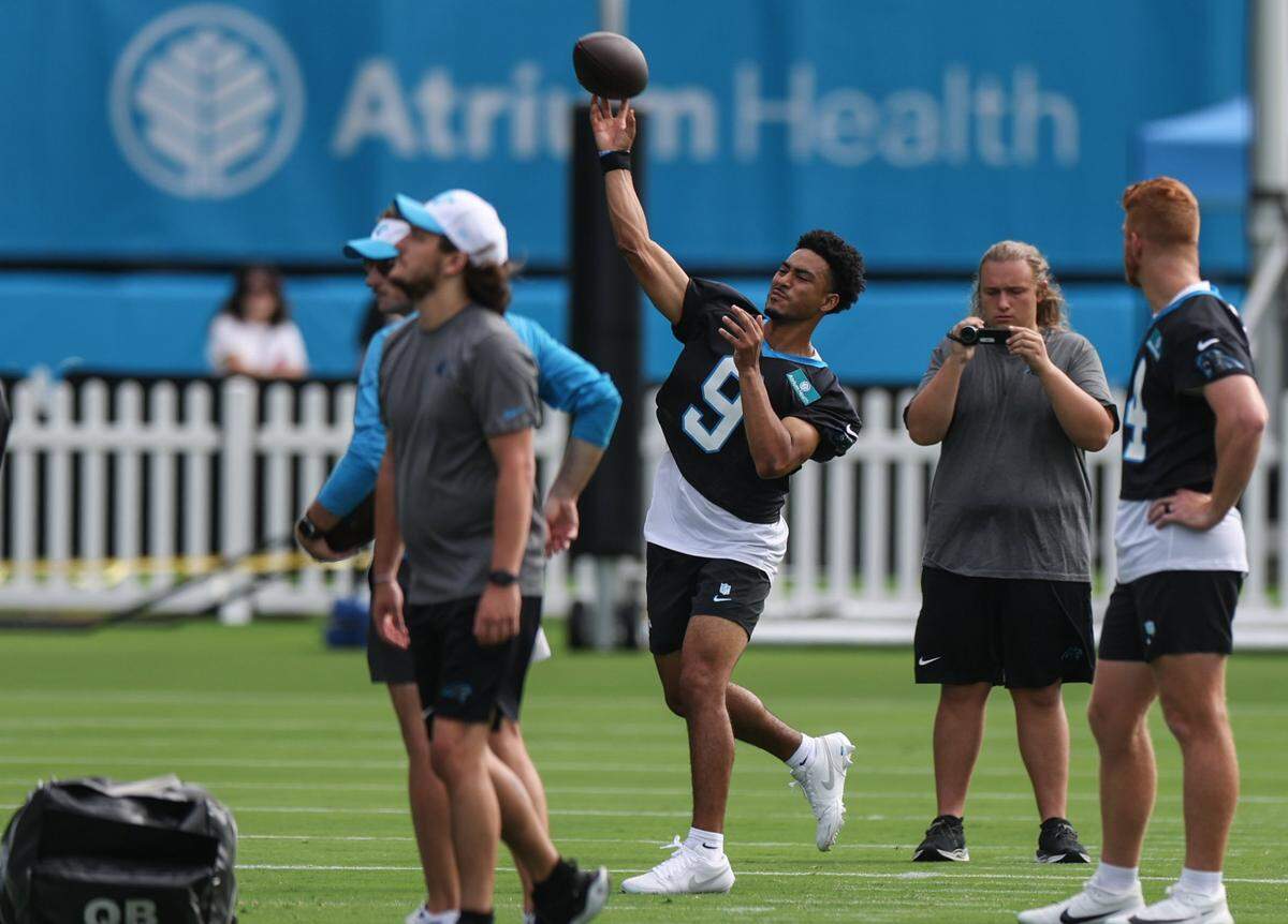Panthers quarterback Bryce Young, center, throws a pass during day one of training camp practice in Charlotte, NC on Wednesday, July 24, 2024.