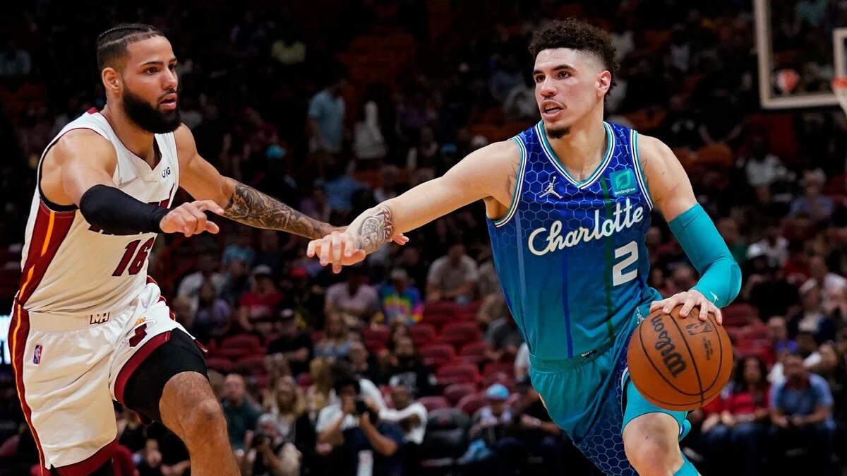 Charlotte Hornets guard LaMelo Ball (2) drives to the basket as Miami Heat forward Caleb Martin (16) defends during the first half of an NBA basketball game Tuesday, April 5, 2022, in Miami. (AP Photo/Lynne Sladky)