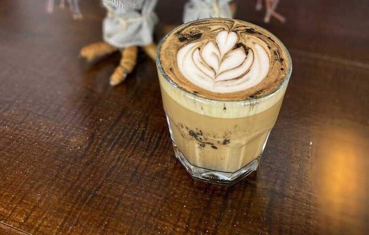 Queen City Grounds’ Campfire Cappuccino is served with a charcoal dusting. 