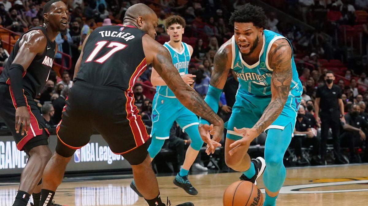Miami Heat forward P.J. Tucker (17) slaps the ball away from Charlotte Hornets forward Miles Bridges (0) during the first half of an NBA basketball game, Friday, Oct. 29, 2021, in Miami. (AP Photo/Marta Lavandier)