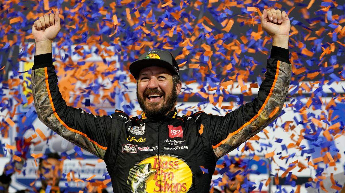 Martin Truex Jr., celebrates winning the NASCAR Cup series auto race in Richmond, Va., Saturday, Sept. 11, 2021. (AP Photo/Steve Helber)