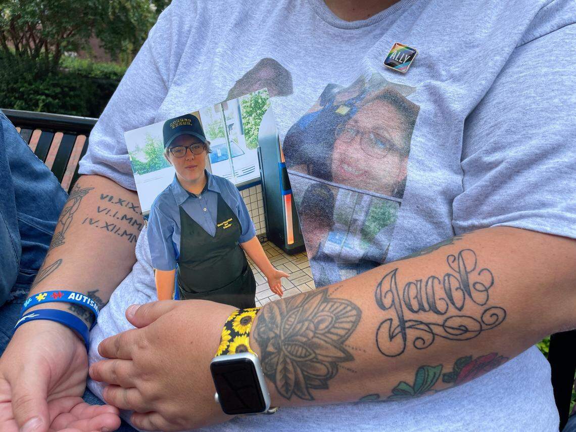 Promise Edwards, 37, holds a photo of Jacob Williamson, her 18-year-old family friend who was murdered, outside Union County Judicial Center in Monroe, N.C., on Tuesday, Aug. 8, 2023. She got a tattoo of the transgender teen’s name four days after he was found dead.