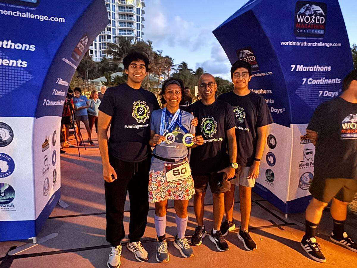 Smita Warrier with her family after finishing her seventh and final marathon in Miami, Florida.