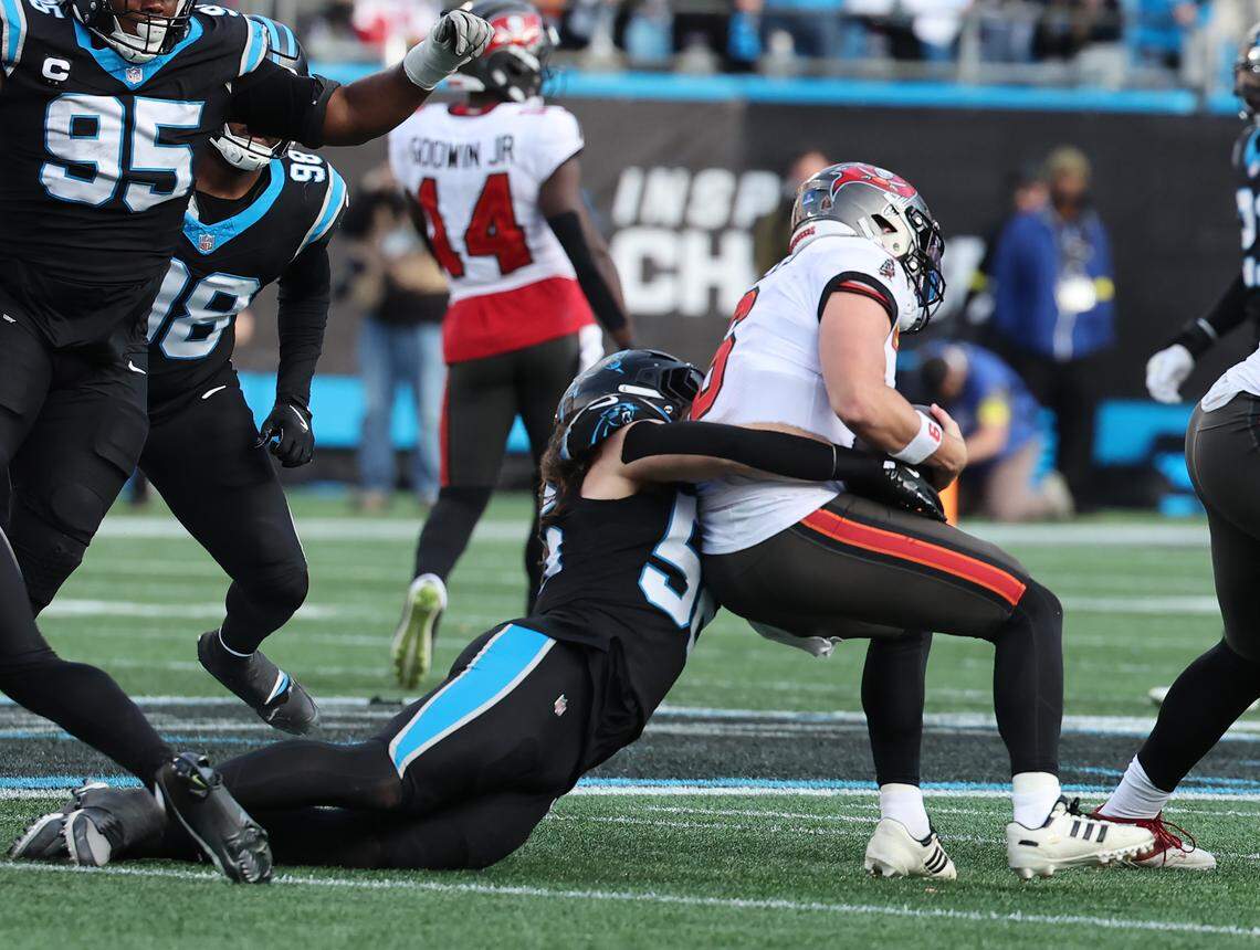 The Carolina Panthers' Christian Rozeboom sacks Tampa Bay Buccaneers quarterback Baker Mayfield during a 2025 game at Bank of America Stadium.