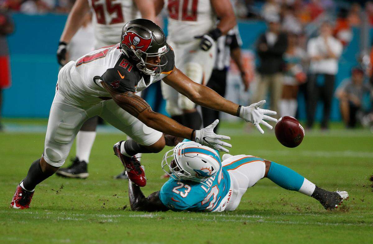 Tampa Bay Buccaneers tight end Jason Reese (81) attempts to hold on to the ball under pressure from Miami Dolphins defensive back Jordan Lucas (23) during the second half of an NFL preseason football game, Thursday, Aug. 9, 2018, in Miami Gardens, Fla. (AP Photo/Wilfredo Lee)