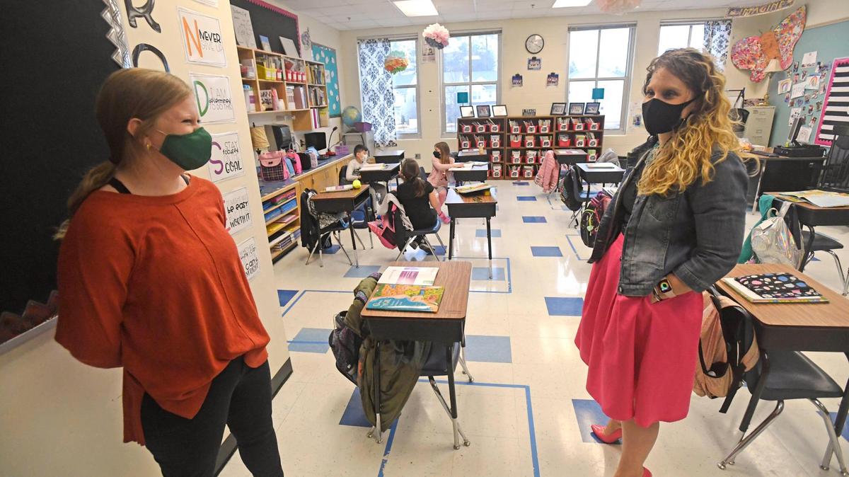 Teaching assistant Hailey Rhodes, left, and third grade teacher Tiffany Hazen, share a laugh at Ballantyne Elementary School on Thursday, February 18, 2021.