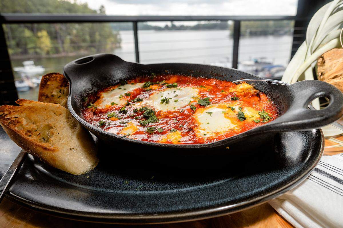 Drift on Lake Wylie serves shakshuka, with pomodoro, goat cheese, bell peppers, caramelized onions, butter toast points and three sunny side up eggs.