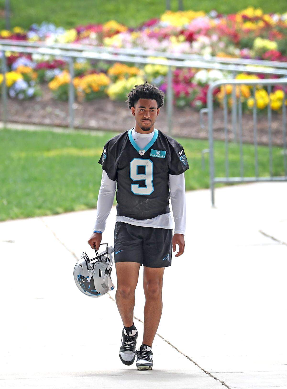 Carolina Panthers quarterback Bryce Young walks to the team’s voluntary minicamp practice on Wednesday, April 24, 2024.