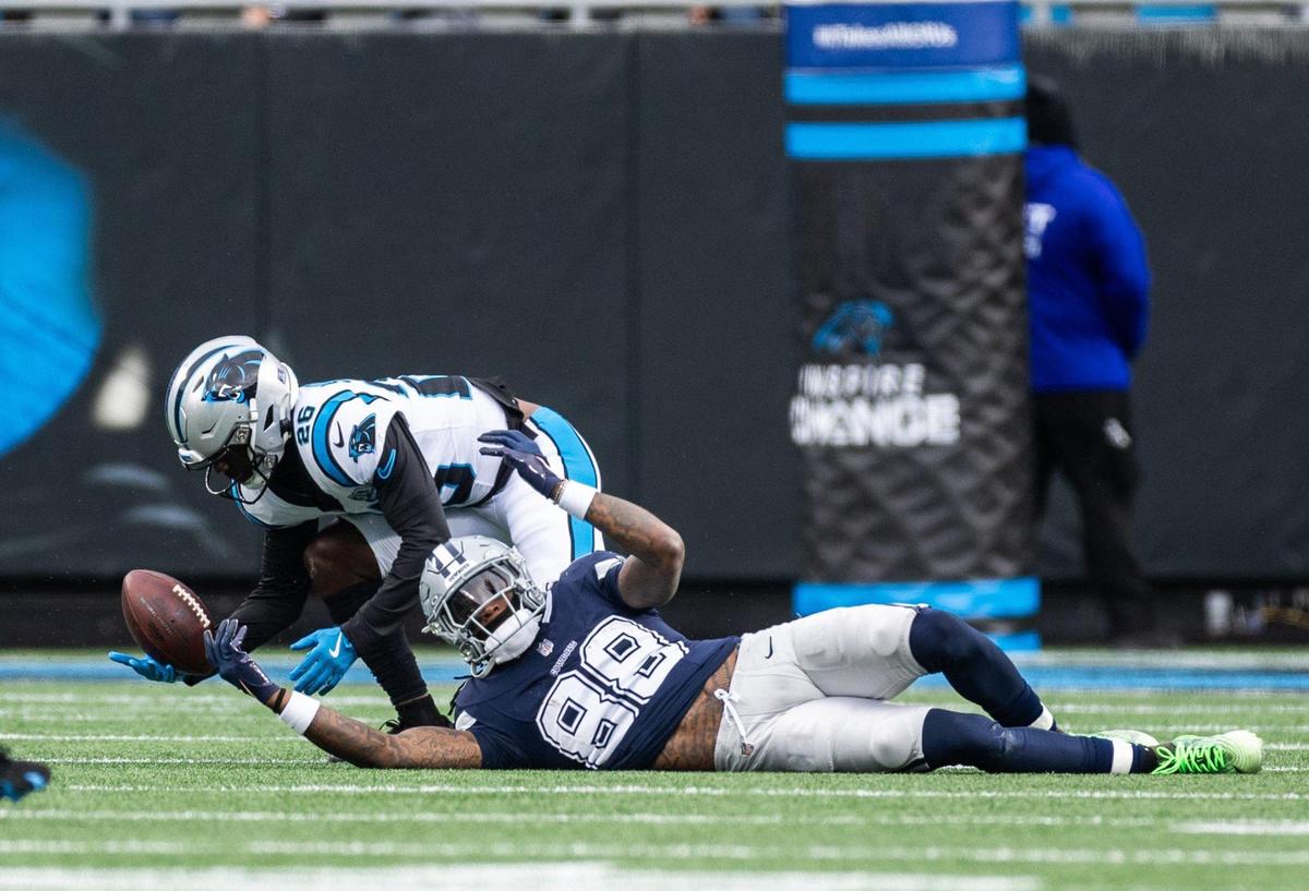 Dallas Cowboys wide receiver CeeDee Lamb, bottom, misses a pass in front of Carolina Panthers cornerback Chau Smith-Wade at the Bank of America Stadium in Charlotte, N.C., on Sunday, December 15, 2024.