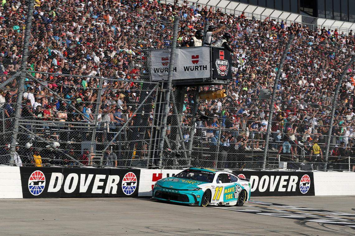 Apr 28, 2024; Dover, Delaware, USA; NASCAR Cup Series driver Denny Hamlin (11) crosses the finish line to win during the Wurth 400 at Dover Motor Speedway.
